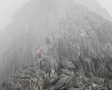 "Crossing the Knife Edge V" - A hiking party carefully traverses one of the narrow "bridges" of Mt. Katahdin's Knife Edge in winds in excess of 40 mph.