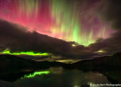 Aurora pillars of green and magenta dance above the Wrightsville Reservoir.