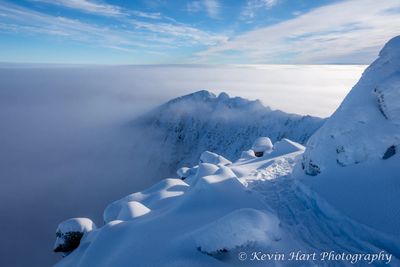 Maine's Katahdin and the Knife Edge covered in snow and wrapped in fog.