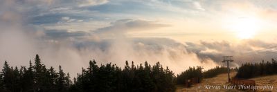 Panorama of a sunrise on Mt. Mansfield, showing Stowe Mountain Resort and rising fog. Vermont in October 2022.