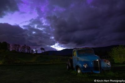 A purple sky from lingering aurora color as the clouds start to turn red from the rising sun.