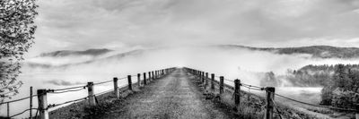 Waterbury Reservoir in Vermont. This panoramic shot is looking down the dam into rising fog and is rendered in black and white.