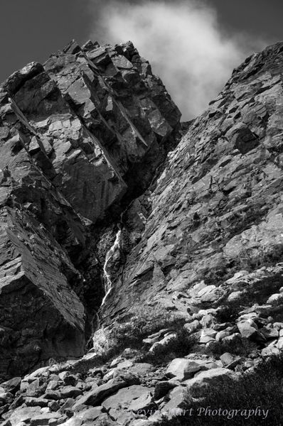 Pinnacle Gully in Huntington Ravine on Mt. Washington in New Hampshire. A tiny stream of water is seen descending through a giant rocky landform. Black and white.